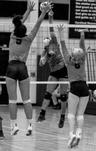 Hammond’s Annisa Evans delivers a kill against Victoria Weaver and Logan Watson. Photo by Perry McLeod