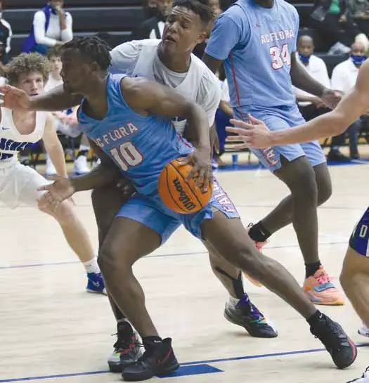 A.C. Flora’s Tyrell Green battles with Dreher’s Marvin Hires to get into the paint. Photo by Mike Maddock