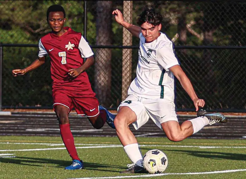 Dutch Fork’s Wyatt Moore passes the ball while being defended by Columbia’s Gabi Lusambya. Photos by Mike Maddock