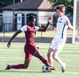 Columbia’s Franck Hendju slides in for a tackle against Dutch Fork’s Owen Jackson.