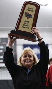 A.C. Flora head coach Amy Martin raises her fourth State Championship trophy in the air. This is her third title with the boys (2015, 2021, and 2025). She also won one with the girls team in 2018.