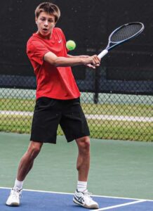 A.C. Flora No. 2 Jude Smyth slices a backhand in his match against Bishop England’s Roland Weir.