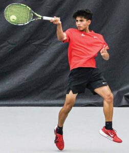 A.C. Flora No. 3 Vijay Sinha returns a deep ball in his match against Bishop England’s Colin Murray.