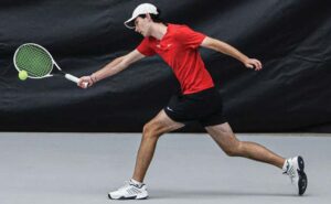 A.C. Flora No. 5 William Beasley lunges for a shot in his match against Bishop England’s Lucas Rizzetto.