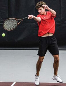 Tripp Van Vlake, A.C. Flora No. 2 doubles, returns a serve against the Bishop England team of Andrew Hamilton and Caleb Watson.