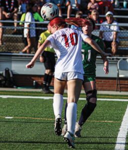 A.C. Flora’s Ashlynn Capell heads a ball as Bishop England’s Rosie Cunnane defends.