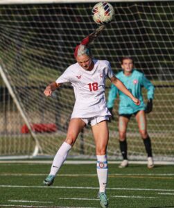 A.C. Flora’s Addie Coffer heads the ball away from the Falcon box.