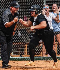 Gray Collegiate’s Kaley Anderson fist bumps head coach Doug Frye as she rounds third after hitting a two-run home run in the bottom of the sixth to extend the War Eagles’ lead to 5-2 against York.