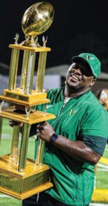 Viking head coach Norman Washington holds the Sword & Saber trophy, which returns to Spring Valley after two seasons at Richland Northeast.