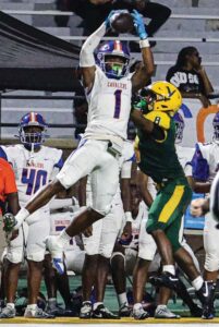 Richland Northeast’s Isaiah Small leaps for a 69-yard touchdown as Spring Valley’s Kam Portee-Broadwater defends.