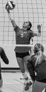 Cardinal Newman’s Addisyn Fernandez focuses on the ball as Hammond’s Anna Claire Sanders looks on.