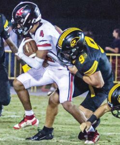 Ben Lippen’s Drake Porter tries to bring down Cardinal Newman’s Alan Rodriguez.