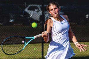 Hammond No. 4 Harper Plymale hits a running forehand in her match against Heathwood Hall’s Amelia Baker.