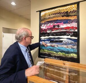 Lancaster shows a wall hanging which included the bow ties from the 2014 event that landed Brittons in the Guinness Book of World Records.