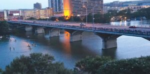 Hundreds of spectators line the Congress Avenue Bridge in Austin, Texas to watch millions of Mexican free-tailed bats forage for insects. Photos by Arlene Marturano