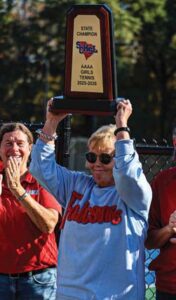 A.C. Flora head girls & boys tennis coach Amy Martin holds up her fifth State Championship trophy. Martin has three with the boys and now two with the girls.