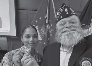 Each guest speaker receives a Post Commander’s Challenge Coin. U.S. Air Force Technical Sergeant Diane Kiser is pictured with L.Z. Harrison Jr.
